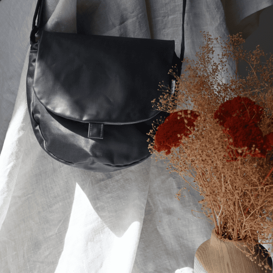 Flap of small shoulder bag light denim