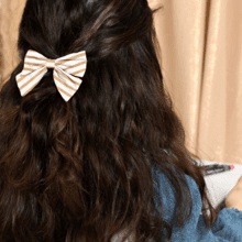 Bow tie hair slide rayé or blanc