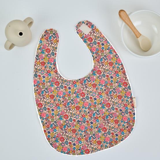 Coated fabric bib mille et une fleurs