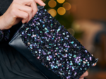 Flap of shoulder bag purple black sequin